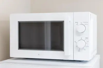 a white microwave oven sitting on a white shelf at Parkview, 3min by Train to Shibuya, 5min by Train to Shinjuku in Tokyo