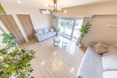 a living room with a couch and a table at Parkview, 3min by Train to Shibuya, 5min by Train to Shinjuku in Tokyo