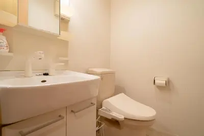 a white bathroom with a sink and a toilet at Belle Lead 106 in Tokyo