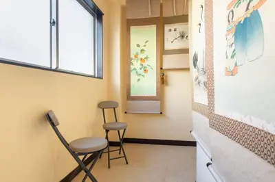 a room with two stools and a window at Max 9 people 8 minutes from Shibuya 5 minutes from Shinjuku 1 minute from Harajuku 4 minutes walk from the station Room Sakura in Tokyo