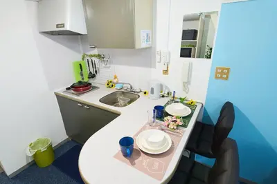 a small kitchen with a table and a sink at SC 202 Cozy Private Stay with Loft Near Station Free WiFi in Tokyo