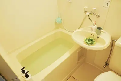 a bathroom with a sink and a bath tub at SC 202 Cozy Private Stay with Loft Near Station Free WiFi in Tokyo