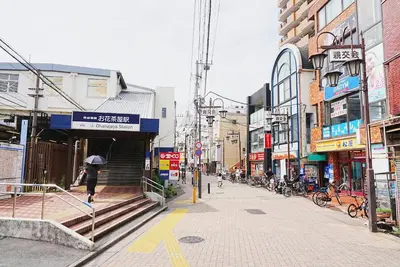 a person walking down a street with an umbrella at SC 202 Cozy Private Stay with Loft Near Station Free WiFi in Tokyo