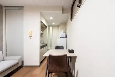 a living room with a table and a couch at JAPT Gotanda in Tokyo