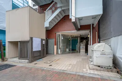 a building with a toilet sitting outside of it at JAPT Gotanda in Tokyo