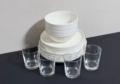 a stack of plates and glasses on a table at JAPT Gotanda in Tokyo