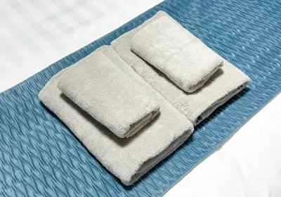 a pair of towels sitting on top of a mattress at JAPT Gotanda in Tokyo