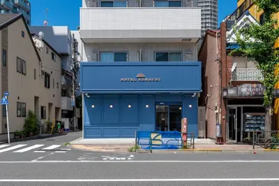 a store with a blue facade on a city street at HOTEL KOMACHI TOKYO Higashi Nippori in Tokyo