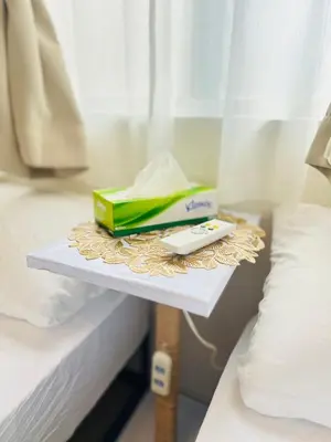 a tray with a book and a phone on a bed at Ueno Uguisudani Tokan in Tokyo