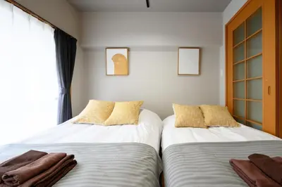 two beds sitting next to each other in a bedroom at Near Shibuya Station 4Beds 5Max A175 in Tokyo