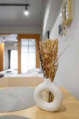 a white vase with flowers in it on a table at Near Shibuya Station 4Beds 5Max A175 in Tokyo