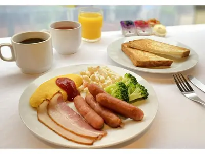 two plates of breakfast food with eggs bacon broccoli and toast at Smile Hotel Tokyo Nishikasai - Vacation STAY 97283v in Tokyo