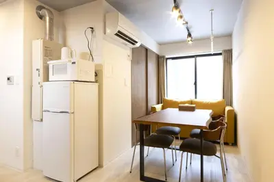 a small kitchen with a table and a refrigerator at HeureuxShiinamachi - Vacation STAY 19768 in Tokyo