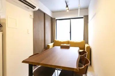 a dining room with a table and a couch at HeureuxShiinamachi - Vacation STAY 19768 in Tokyo