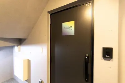 a black elevator door with a sign on it at HeureuxShiinamachi - Vacation STAY 19768 in Tokyo