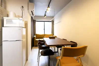 a kitchen and dining room with a table and a refrigerator at HeureuxShiinamachi - Vacation STAY 19768 in Tokyo