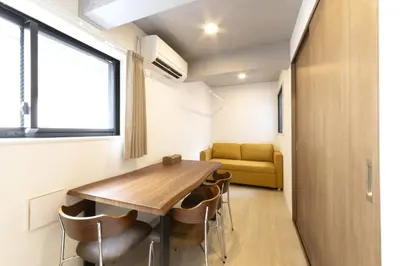 a room with a table and chairs and a couch at HeureuxShiinamachi - Vacation STAY 19769 in Tokyo