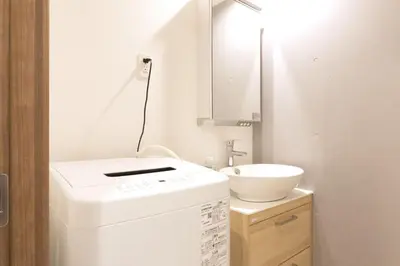 a small bathroom with a sink and a washing machine at HeureuxShiinamachi - Vacation STAY 19769 in Tokyo
