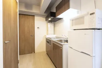 a kitchen with a white refrigerator and a sink at HeureuxShiinamachi - Vacation STAY 19769 in Tokyo
