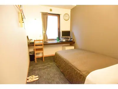 a bedroom with a bed and a desk and a window at Kamata Inn Social - Vacation STAY 03288v in Tokyo