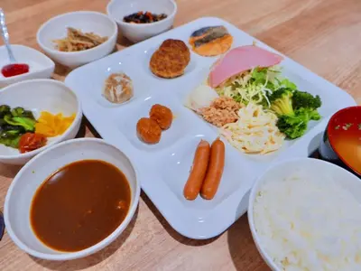 a plate of food with soup and vegetables on a table at Kamata Inn Social - Vacation STAY 03309v in Tokyo
