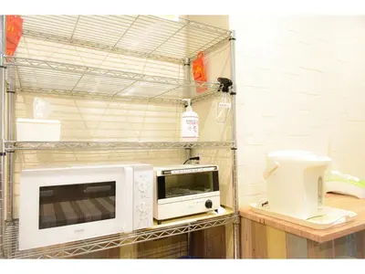 a microwave and a toaster oven on a shelf at Kamata Inn Social - Vacation STAY 03309v in Tokyo