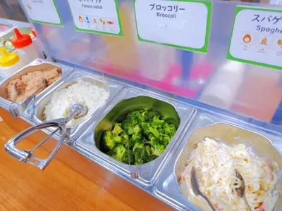 a plastic container of food with broccoli and rice at Kamata Inn Social - Vacation STAY 03314v in Tokyo