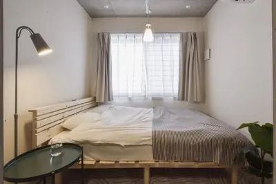 a bedroom with a bed and a glass table at La Residence East Tokyo101 - Vacation STAY 19855 in Tokyo