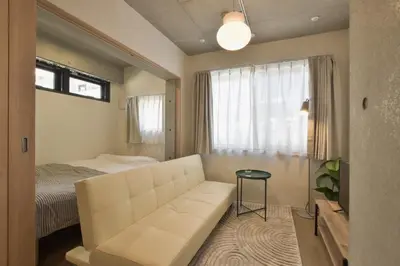 a living room with a couch and a bed at La Residence East Tokyo301 - Vacation STAY 19857 in Tokyo
