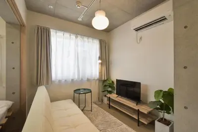a living room with a white couch and a television at La Residence East Tokyo301 - Vacation STAY 19857 in Tokyo