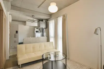a living room with a couch and a glass table at La Residence East Tokyo202 - Vacation STAY 19859 in Tokyo