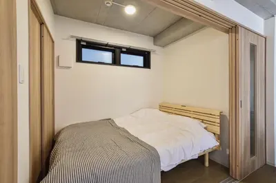 a small bedroom with a bed and a window at La Residence East Tokyo202 - Vacation STAY 19859 in Tokyo
