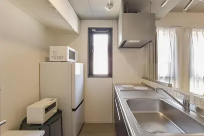 a kitchen with a sink and a refrigerator at La Residence East Tokyo302 - Vacation STAY 19860 in Tokyo