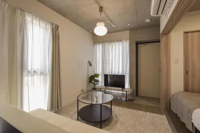 a living room with a couch and a glass table at La Residence East Tokyo302 - Vacation STAY 19860 in Tokyo