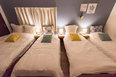 two beds sitting next to each other in a room at Wakabayashi house in Tokyo