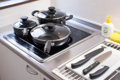 two pots and pans on a stove in a kitchen at Wakabayashi house in Tokyo