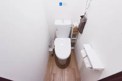 a bathroom with a white toilet in a room at Wakabayashi house in Tokyo