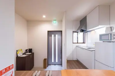 a small kitchen with a refrigerator and a microwave at Wakabayashi house in Tokyo
