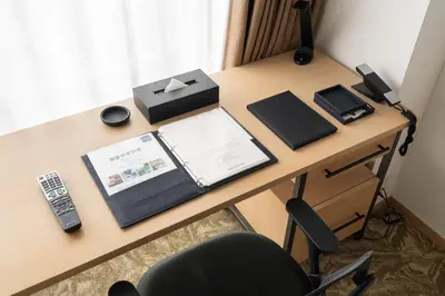 a desk with a phone and a box on it at \u6771\u6025\u30b9\u30c6\u30a4\u56db\u8c37 in Tokyo