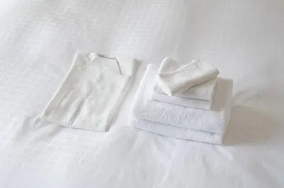 two towels sitting on top of a bed at \u6771\u6025\u30b9\u30c6\u30a4\u56db\u8c37 in Tokyo