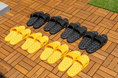 a group of yellow and black shoes on a patio at \u6674\u30ec\u5c4b\u6d45\u8349 Hareya Asakusa in Tokyo