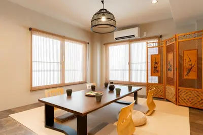 a dining room with a table and chairs at \u6674\u30ec\u5c4b\u6d45\u8349 Hareya Asakusa in Tokyo