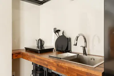 a kitchen counter with a sink and a mixer at \u6674\u30ec\u5c4b\u6d45\u8349 Hareya Asakusa in Tokyo
