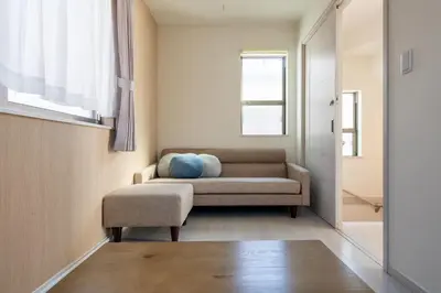 a living room with a couch and a window at Detached house in Oshima 4chome, one train ride to Shinjuku \u5927\u5cf64\u4e01\u76ee in Tokyo