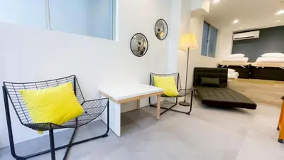 a room with a desk and chairs and a bed at YadoyaTamachi 101 in Tokyo