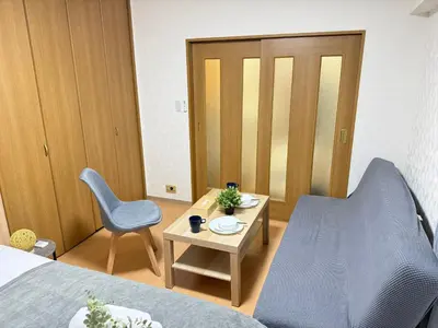a bedroom with a bed and a table and a chair at Shinjuku Area 42 Shinjuku Apartment in Tokyo
