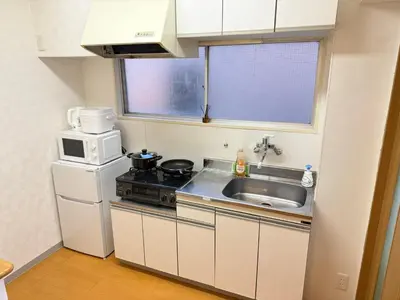 a small kitchen with a stove and a sink at Shinjuku Area 42 Shinjuku Apartment in Tokyo