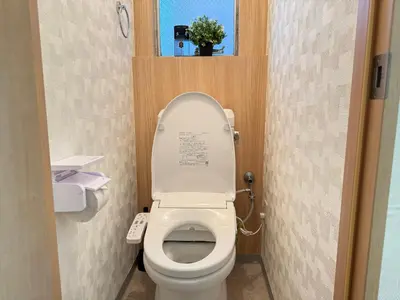 a bathroom with a toilet with the lid up at Shinjuku Area 42 Shinjuku Apartment in Tokyo