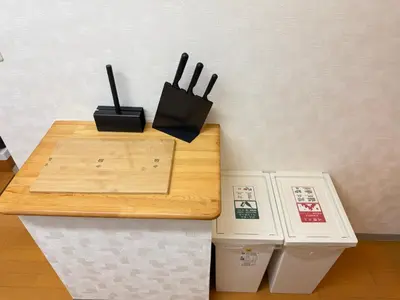 a wooden table next to two trash cans and a counter at Shinjuku Area 42 Shinjuku Apartment in Tokyo