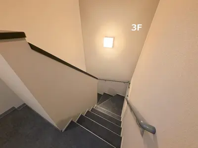 a staircase in a building with a stair case at PRISM Inn Tateishi in Tokyo
